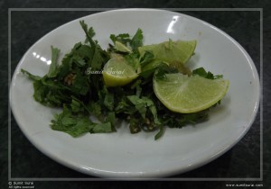 Lemon wedges and chopped coriander, chillies